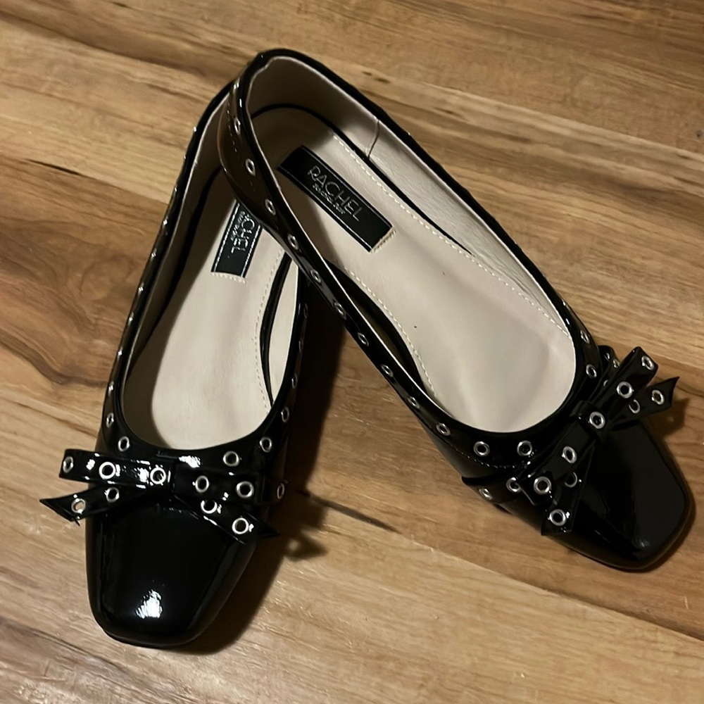 Rachel by Rachel Roy Blink
Rachel Roy black flats with chic silver grommet.